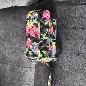Vera Bradley wristlet with black with flowers all over it